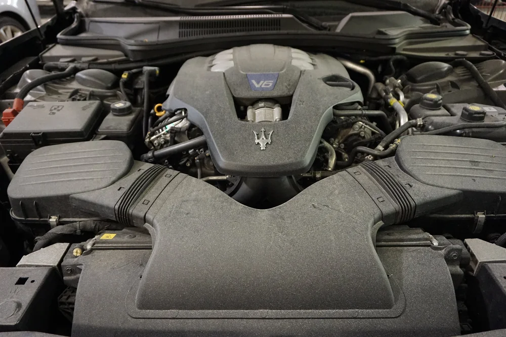 Engine bay of a Maserati opened up during repair at Auto Show Collision Center on Reed Street